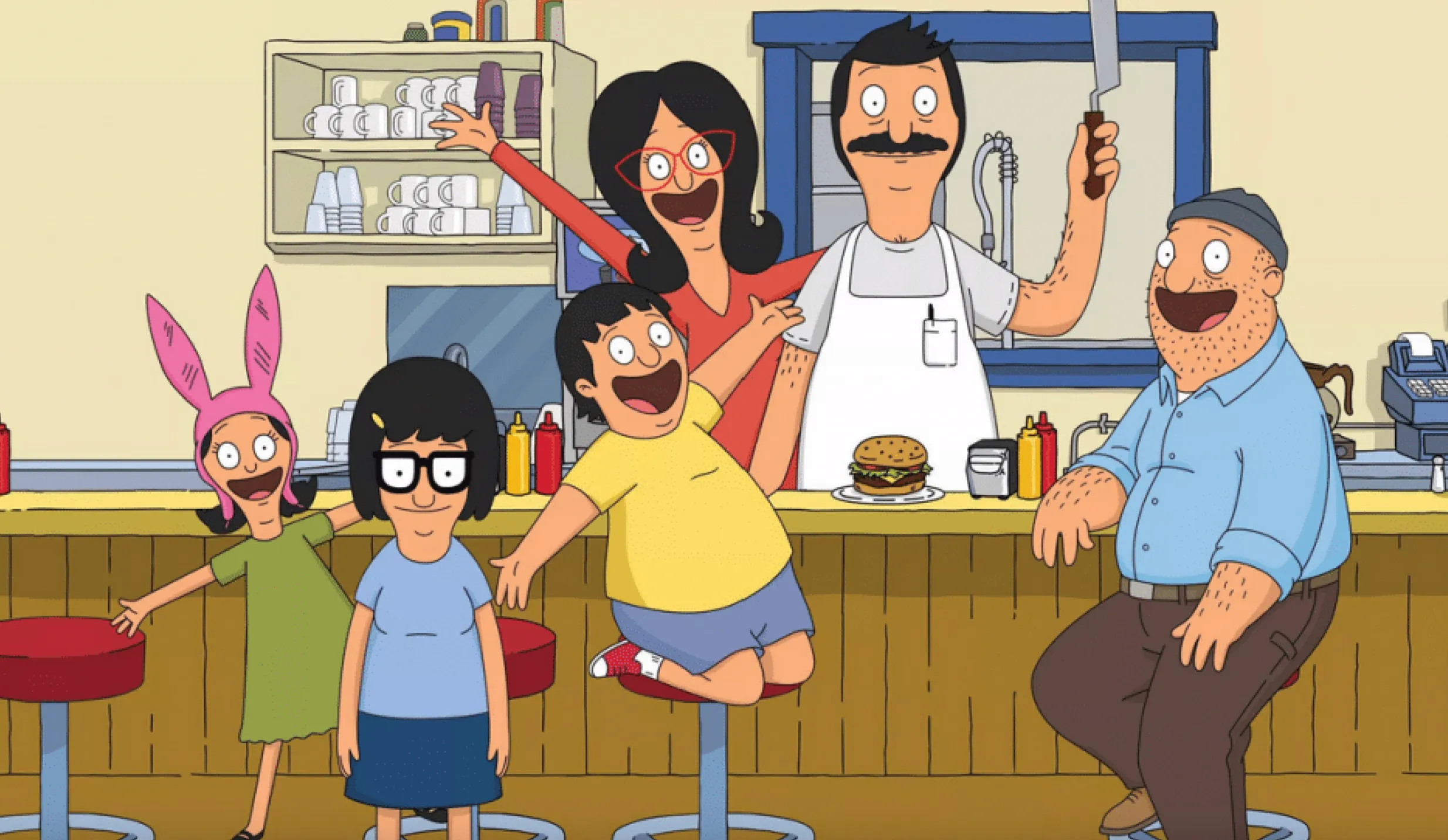 Bob's Burgers characters posing inside their fictional burger restaurant in the animated TV show setting of a small town.