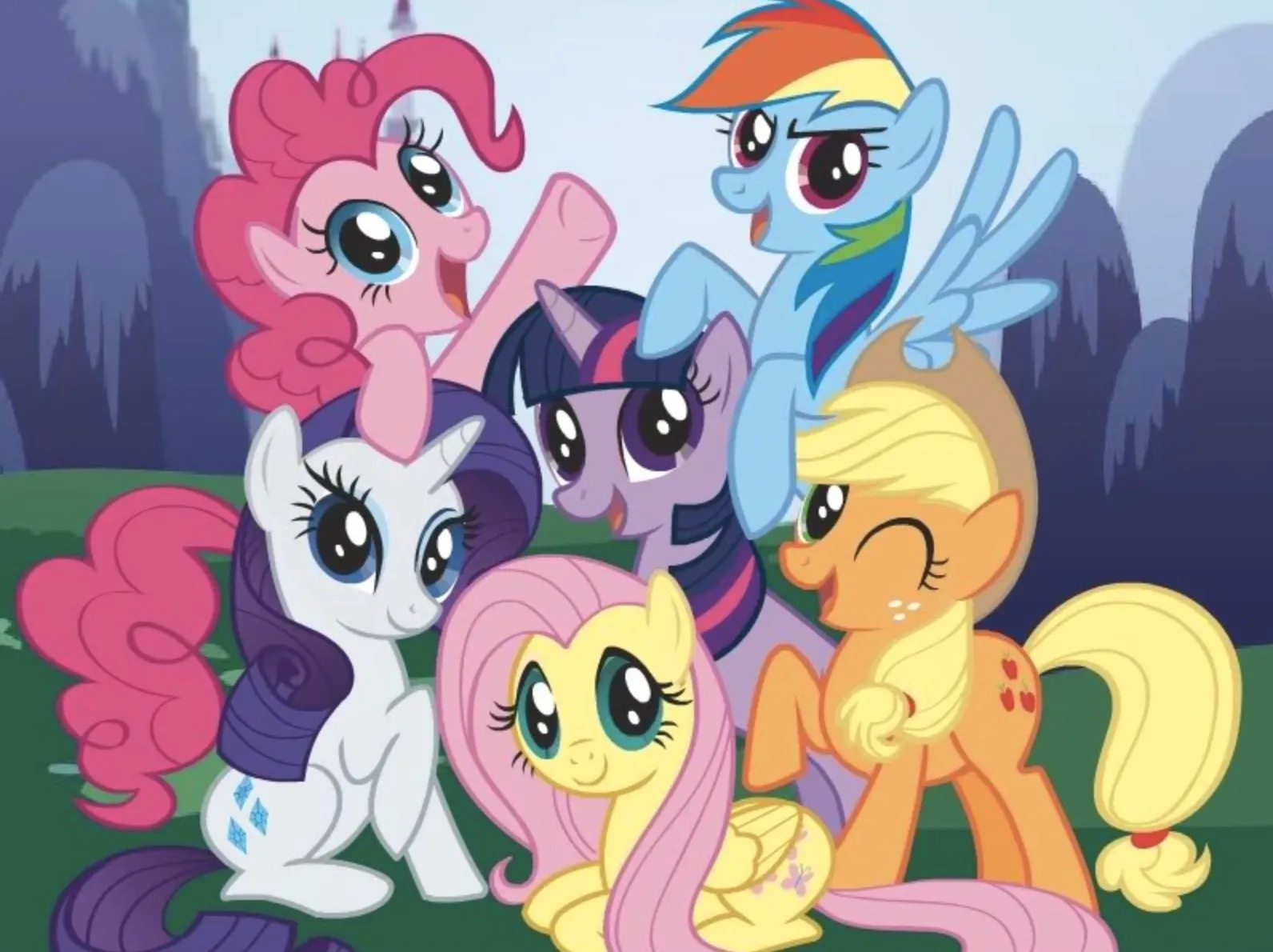 Colorful My Little Pony characters smiling and posing together in a bright animated outdoor setting.