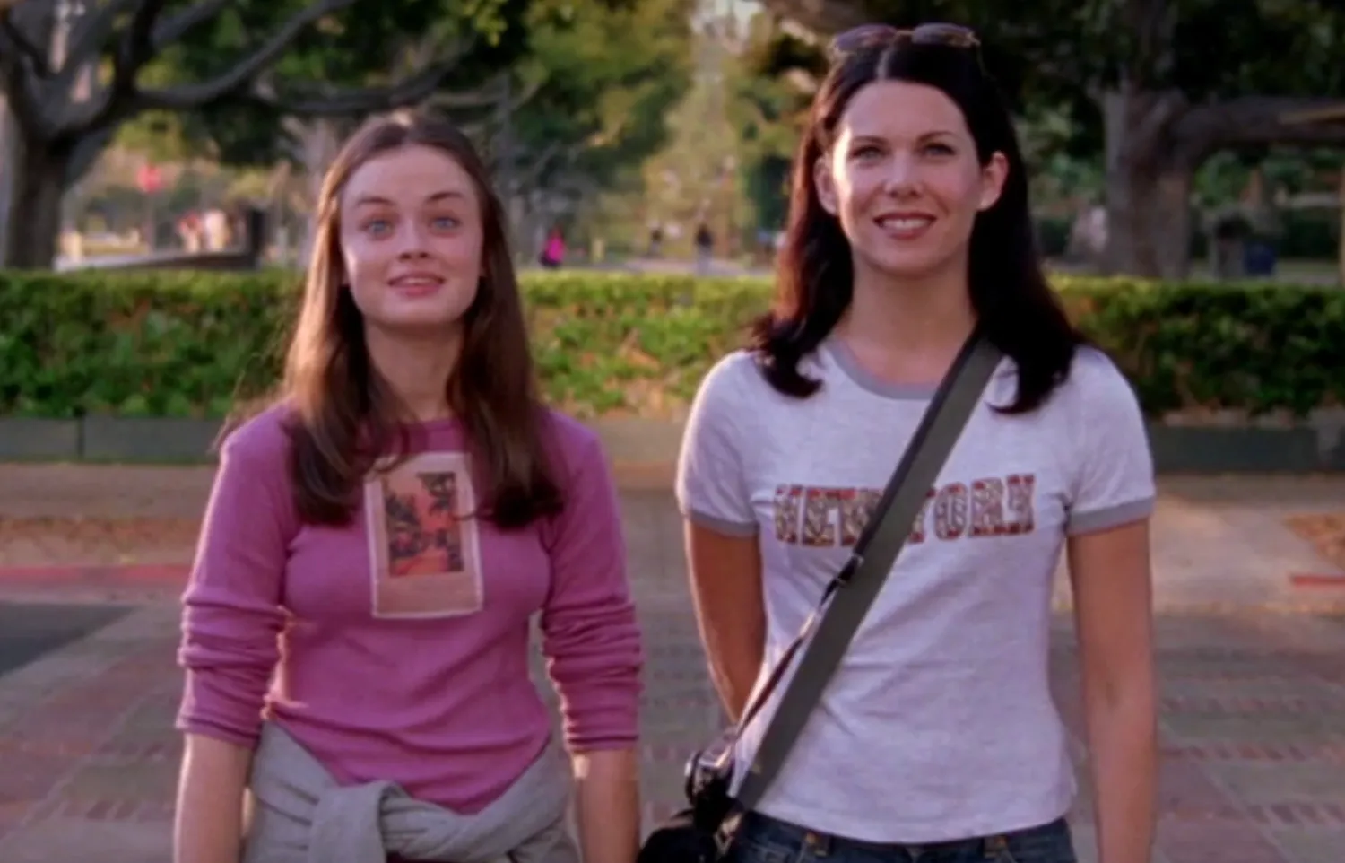 Lorelai and Rory standing outdoors in a cozy town, a key fictional location in popular TV shows.