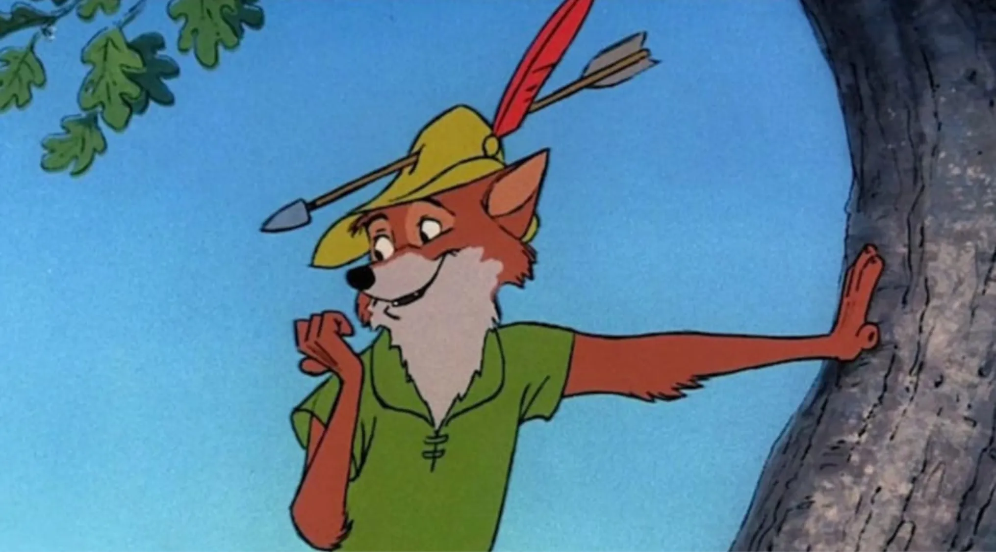 Disney character Robin Hood leaning on a tree wearing a green shirt and yellow hat with a red feather.