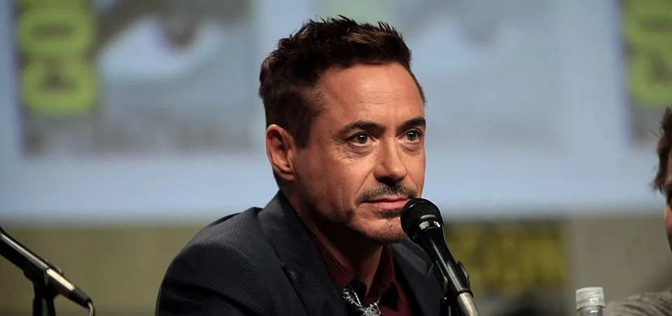 Robert Downey Jr. speaking at a panel, known for playing Tony Stark Iron Man in the Marvel Cinematic Universe.