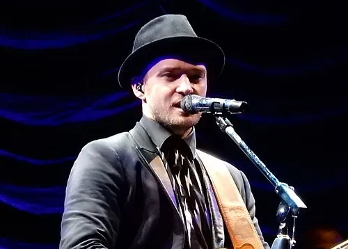 Justin Timberlake performing on stage, related to his highly publicized breakup that inspired Cry Me a River in 2002.