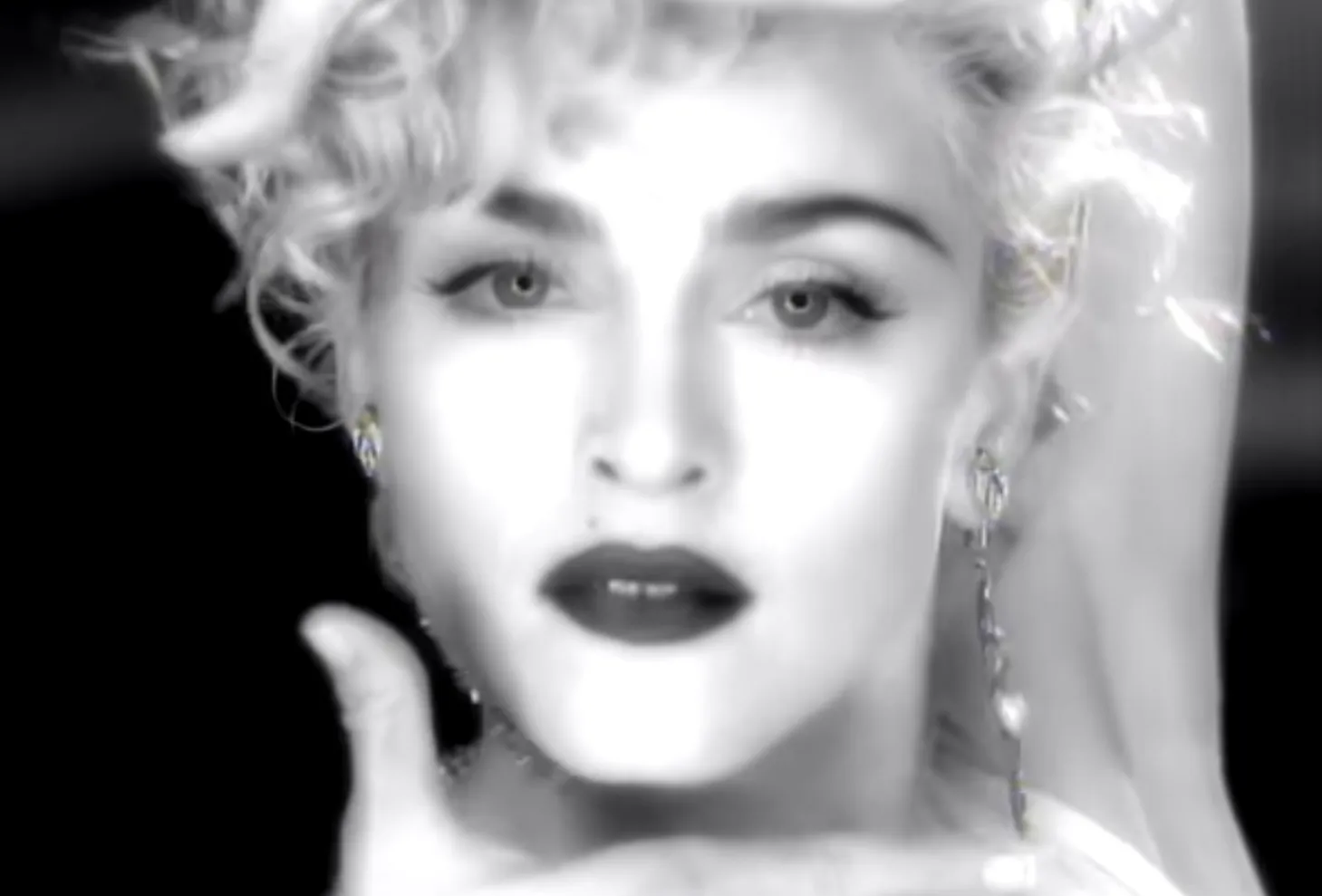 Black and white close-up of Madonna from the Vogue music video known for elaborate 1980s choreography.