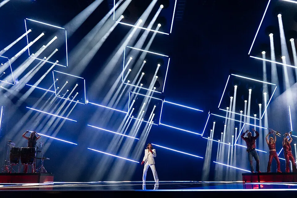 Stage performance with dynamic lighting effects at the Eurovision Song Contest held in its home country.