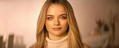 Young woman with blonde hair in a warm-toned setting representing a dystopian reality show for teenagers competing to survive.