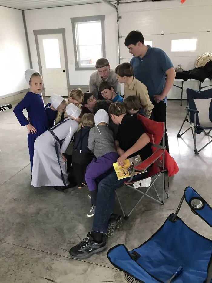 Group of children dressed in plain clothes and bonnets, gathered closely indoors, highlighting tragic hair accidents from hairstylist errors.