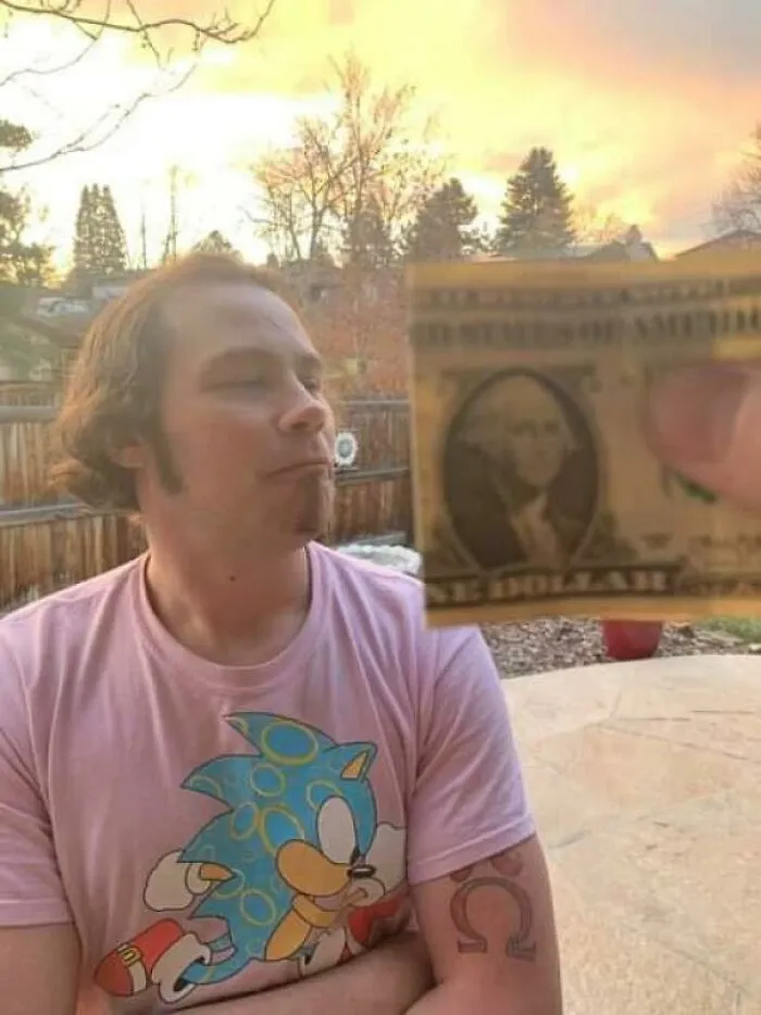 Man with uneven, awkward haircut standing outside during sunset, illustrating a tragic hair accident from hairstylist mistakes.