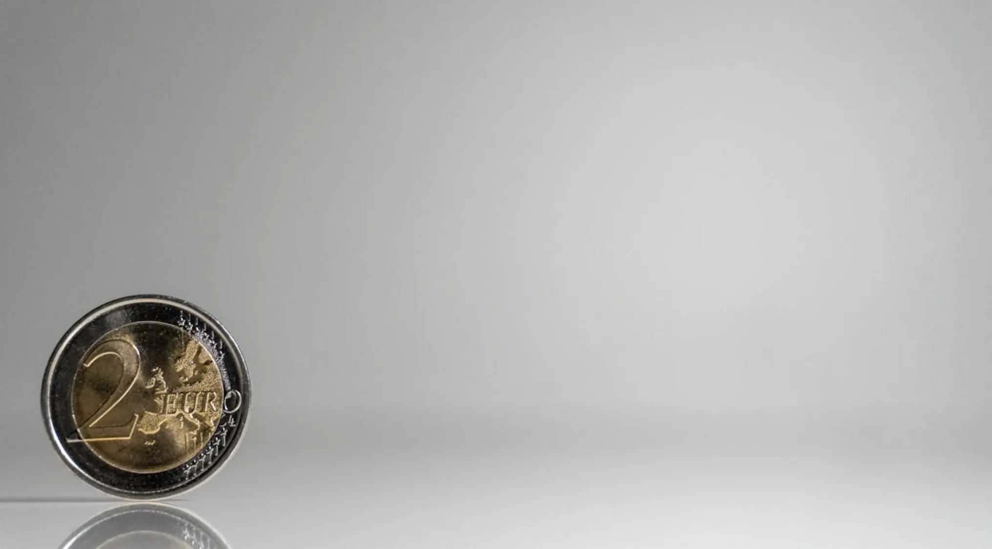 Close-up of a coin standing on edge to represent proving your basic math skills and possible outcomes of a flip.
