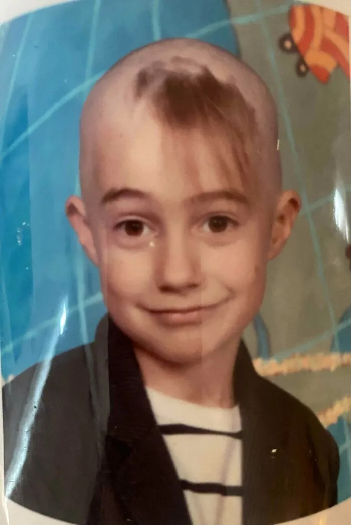 Young boy with uneven, tragic hair accident, showcasing a poorly done hairstyle mistake by a hairstylist.