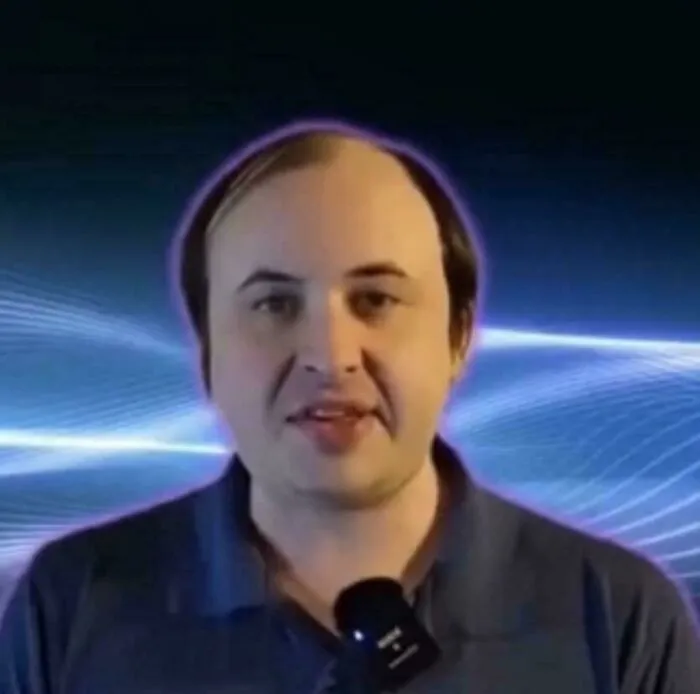 Man with uneven hair and balding scalp speaking against a blue digital background showing tragic hair accidents.