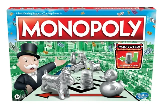 Monopoly classic board game box featuring tokens including a dog, thimble, duck, and top hat on game board.