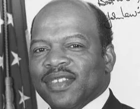 Portrait of John Lewis smiling, with an American flag in the background, related to Atlanta civil rights history.