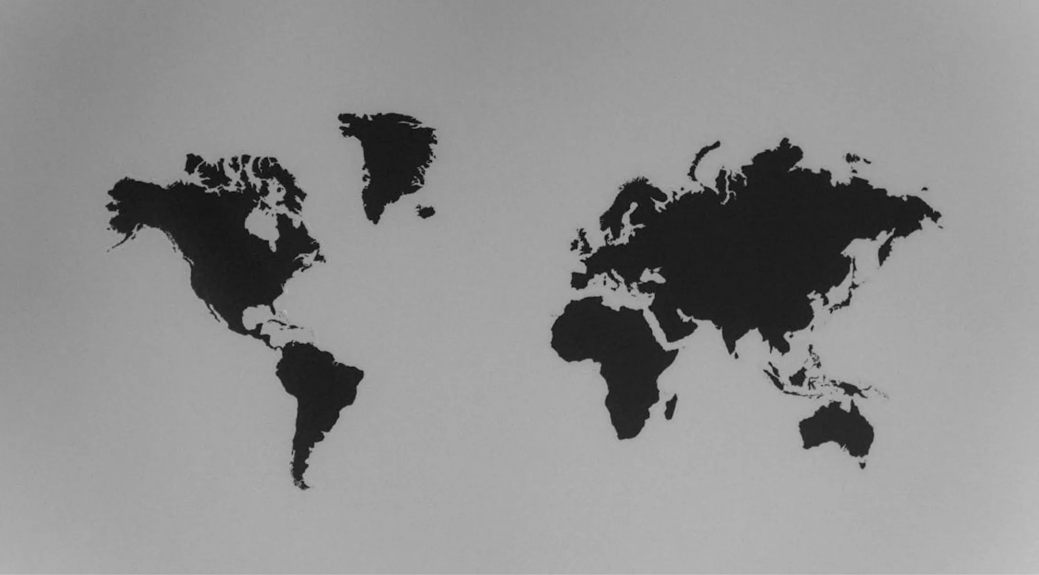Silhouettes of continents on a world map highlighting the largest continent by land area concept.