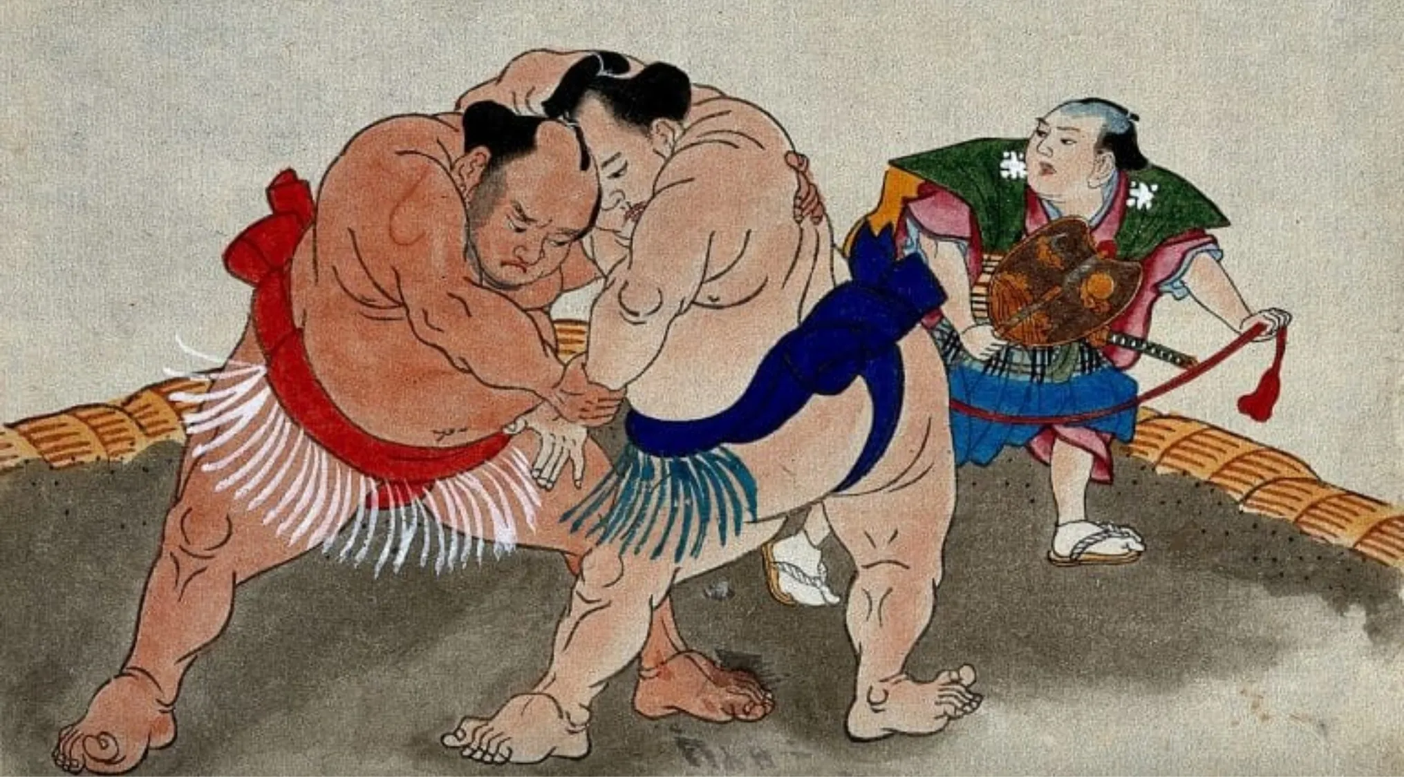 Traditional Japanese sumo wrestlers grappling during a match with a referee observing inside the ring.
