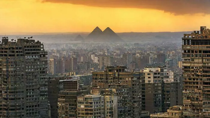 Dense urban landscape filled with high-rise buildings under a hazy sky, highlighting a dystopian urban hell scene.