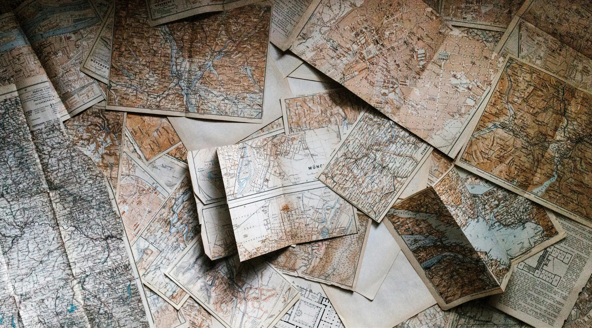 Vintage maps spread out on a surface illustrating countries that are often mixed up in East Africa and South Asia.