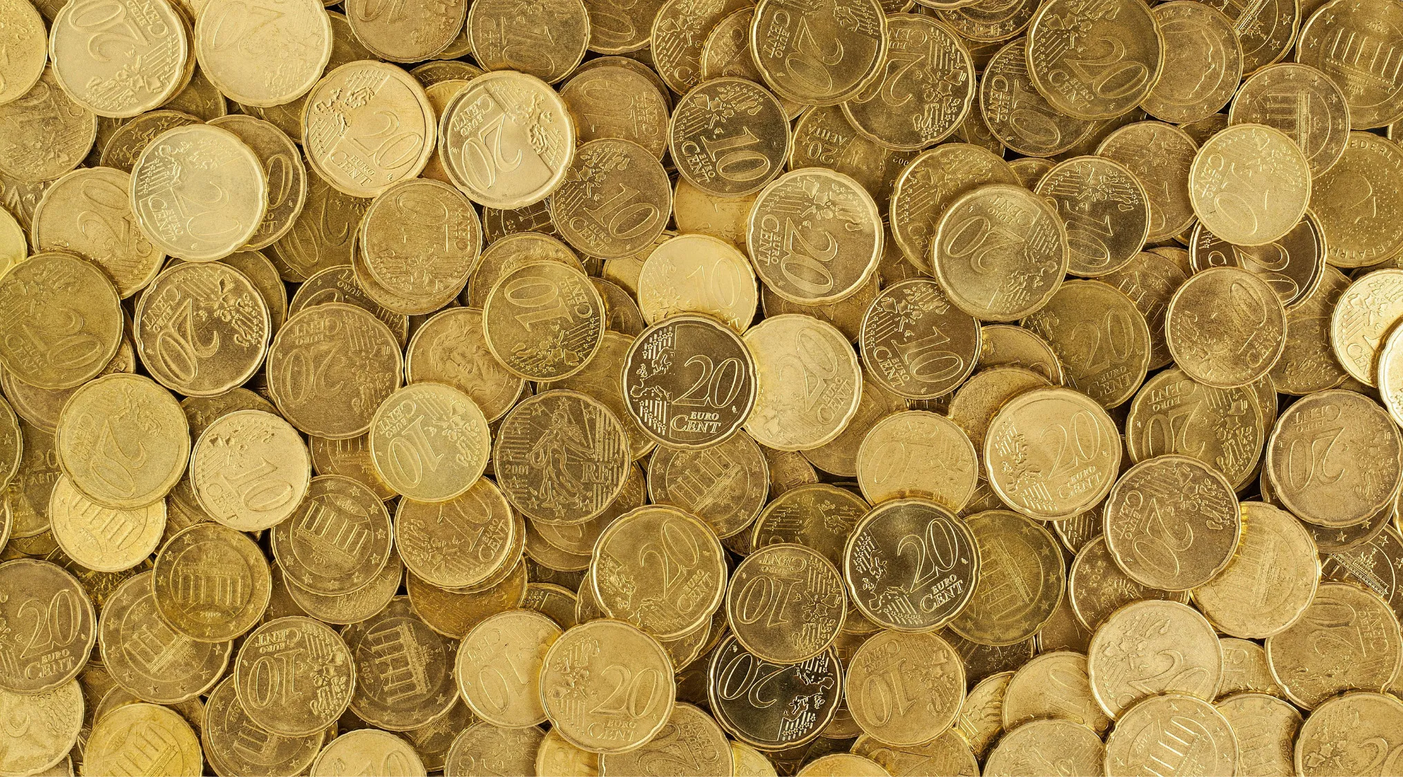 Close-up of various euro coins scattered, illustrating countries that use the euro but are not in the European Union.