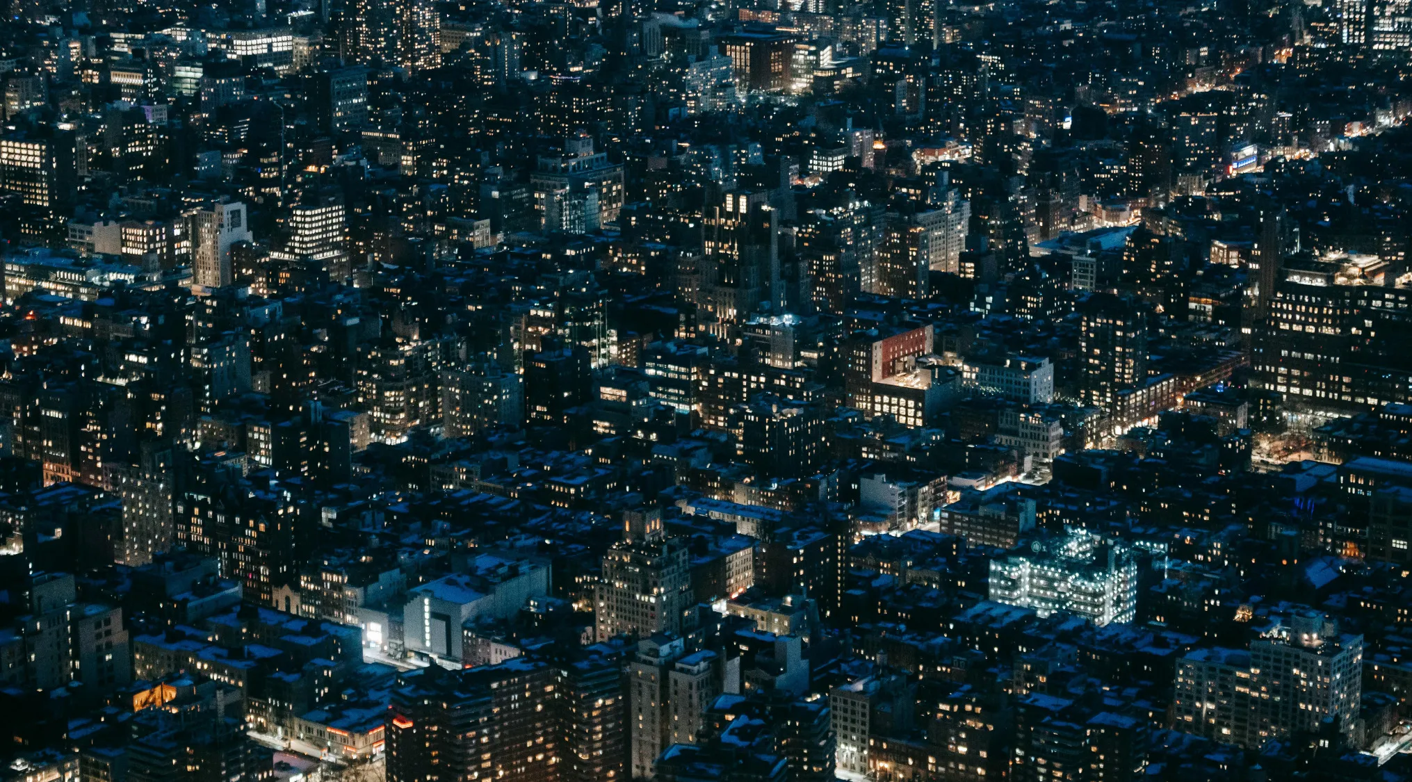 Aerial night view of a cityscape illustrating globalization and cultural expression development from 1900 to 2000.