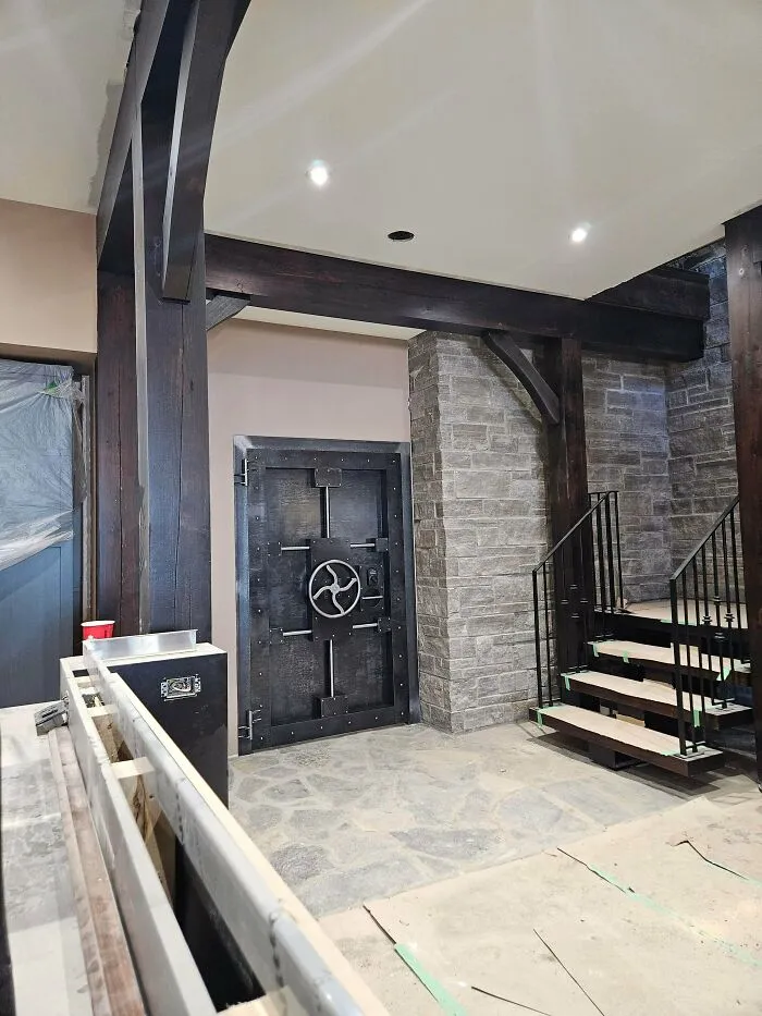 Industrial-style metal door and staircase showcasing metalworkers craftsmanship defying physics and logic indoors.