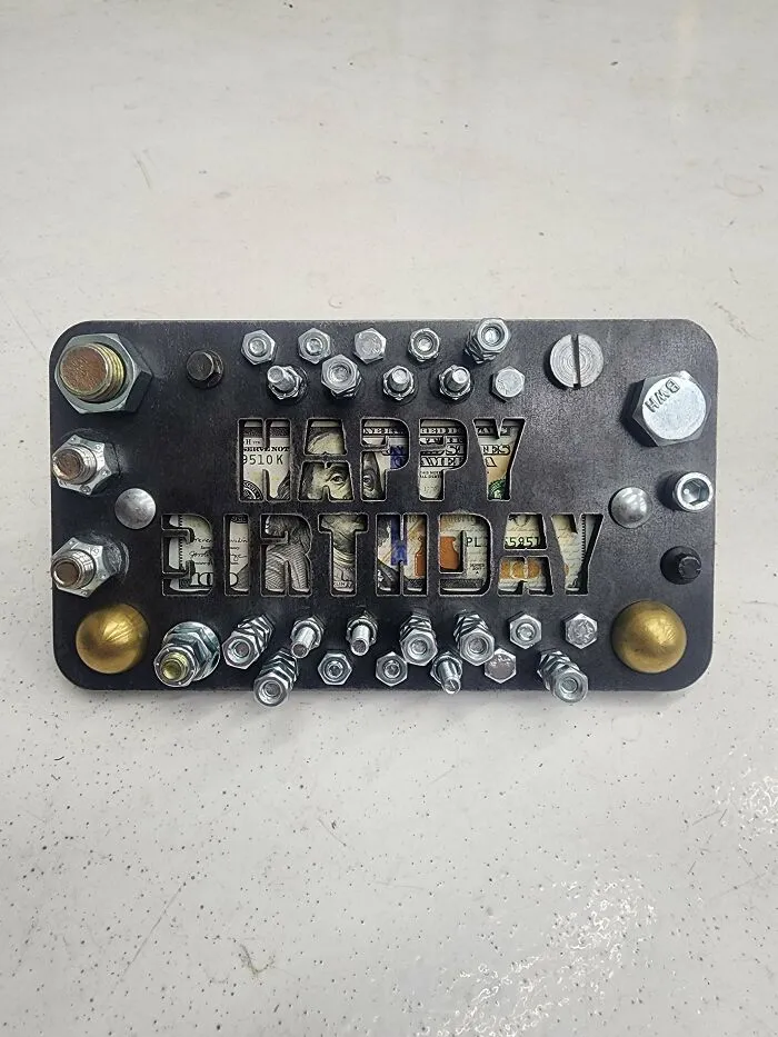 Metalworkers creation with bolts and nuts forming a Happy Birthday sign, showcasing skill and remarkable metalwork design.