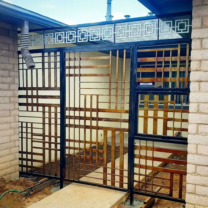Metalworker crafted intricate geometric metal gate defying logic with unique remarkable design and precise craftsmanship.