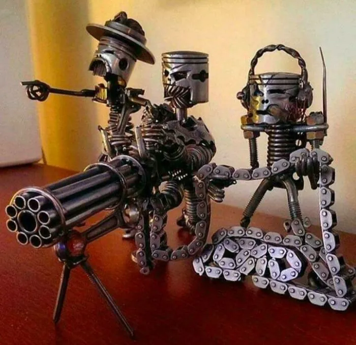 Metalworkers crafted a detailed sculpture of three figures using metal parts, showcasing remarkable skill and creativity.