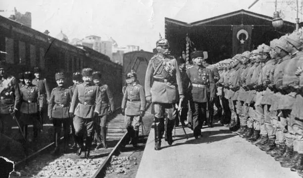 Ottoman Empire soldiers in military uniforms lined up on platform, historical black and white photo from early 20th century.