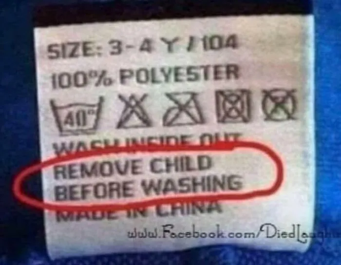 Clothing care label with strange sign saying remove child before washing, highlighting unusual signs that deserve a double take