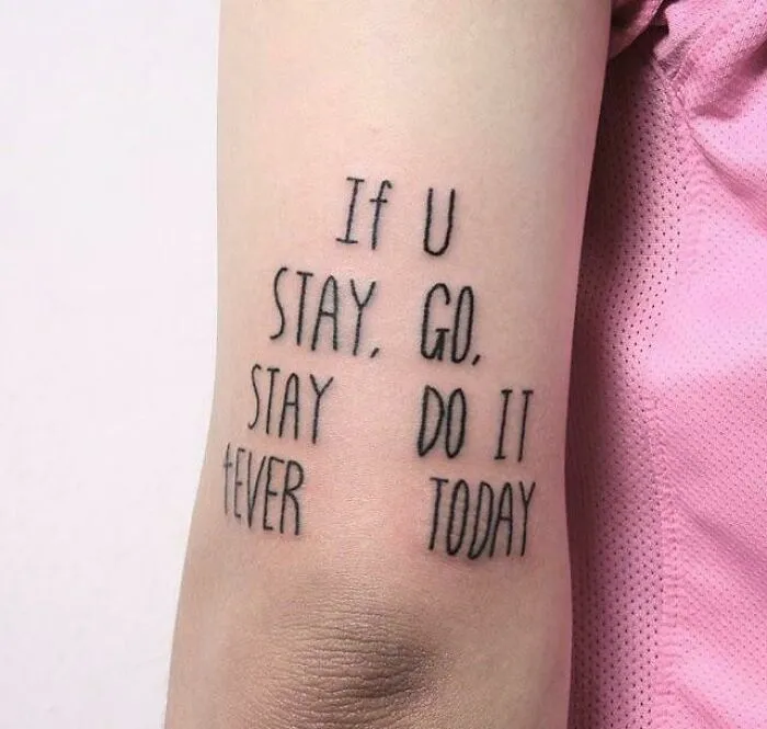 Tattoo with confusing text that shows signs that went wrong and turned into comedic gold on a person's arm.
