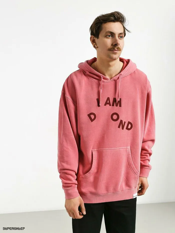 Man wearing a pink hoodie with scrambled letters, an example of signs that went wrong and turned into comedic gold.
