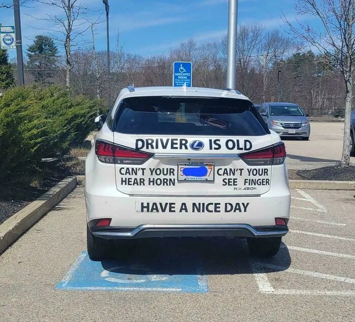 Car parked in a handicapped spot with humorous signs turned wrong, showcasing comedic gold in road signage fails.