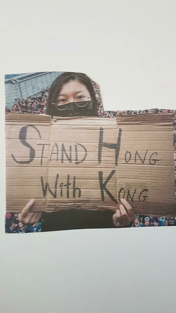 Person holding a cardboard sign with a humorous misspelling that went wrong and turned into comedic gold
