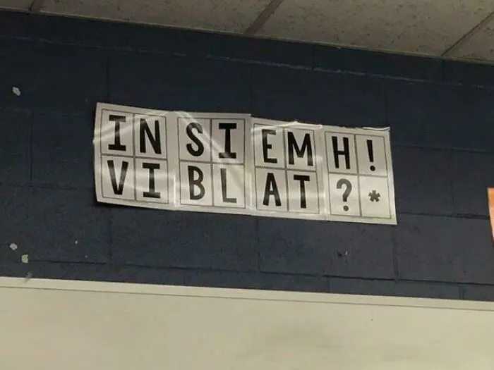 Humorous sign spelling errors creating comedic gold with letters arranged awkwardly on a wall background.