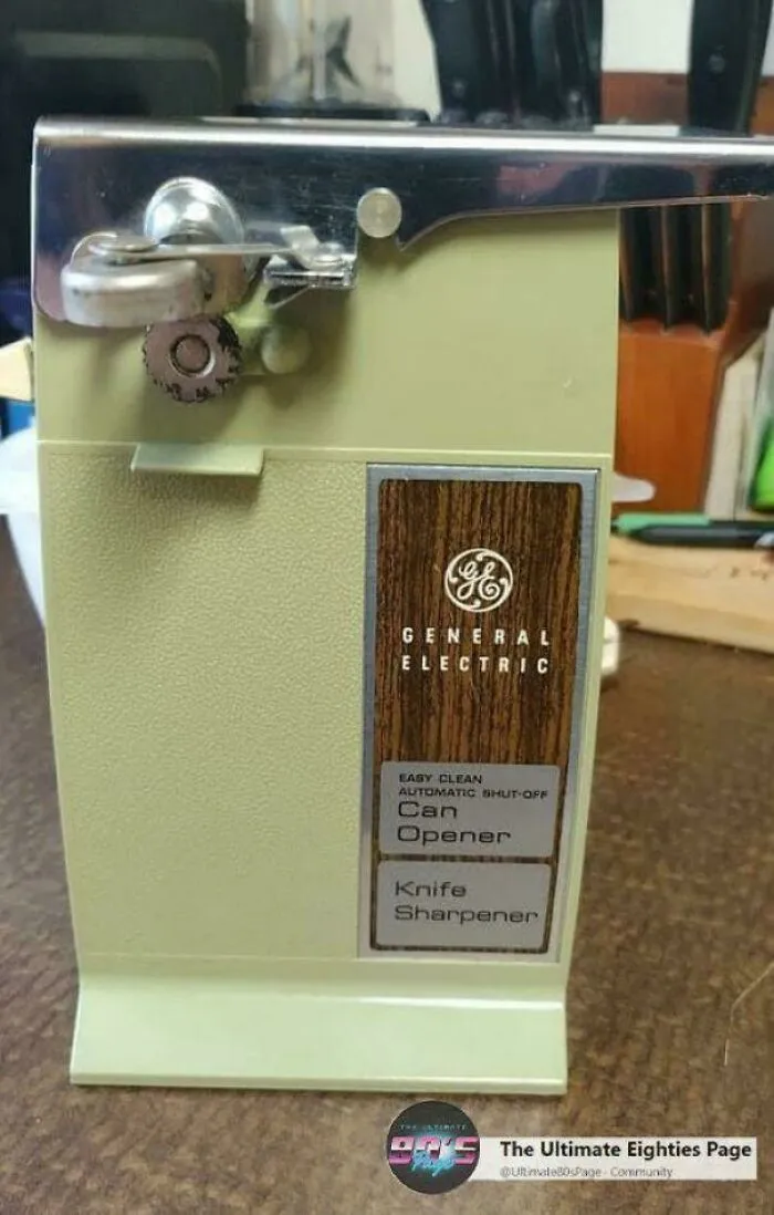 A vintage General Electric electric can opener, light green with a wood-look panel. This image takes you way back.