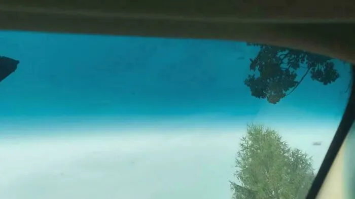 Looking through a vehicle's windshield with a blue tint, a nostalgic image that takes you way back.