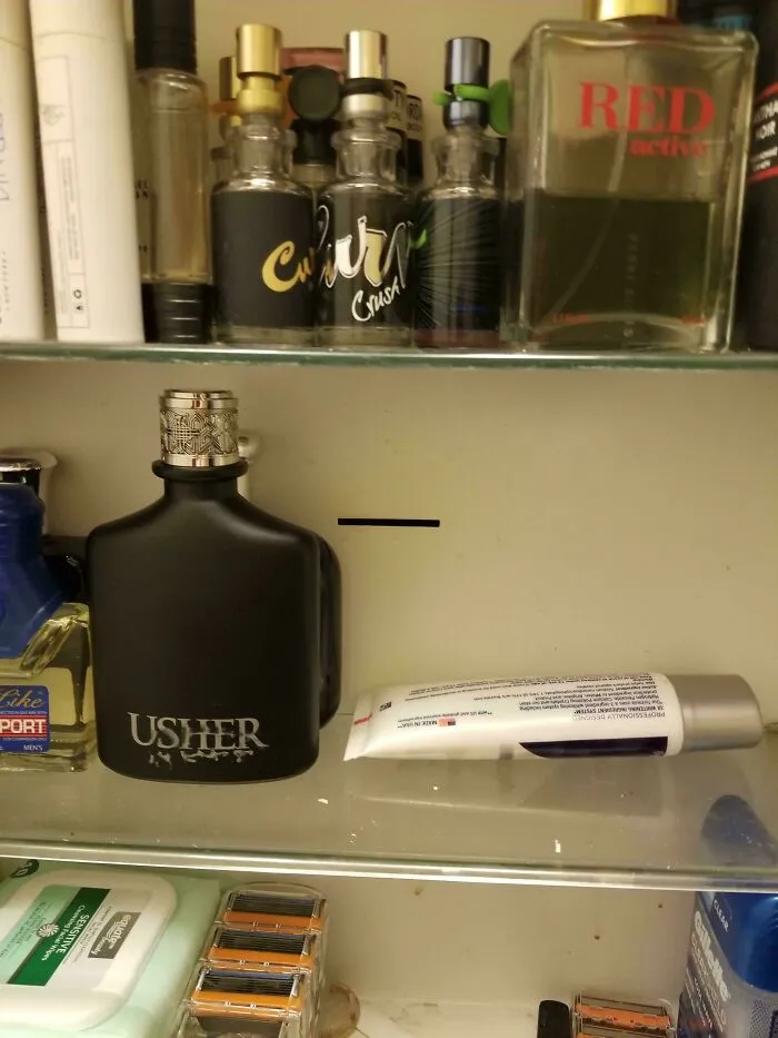 A close-up of a medicine cabinet with various perfumes and toiletries, reminding you how old you are.