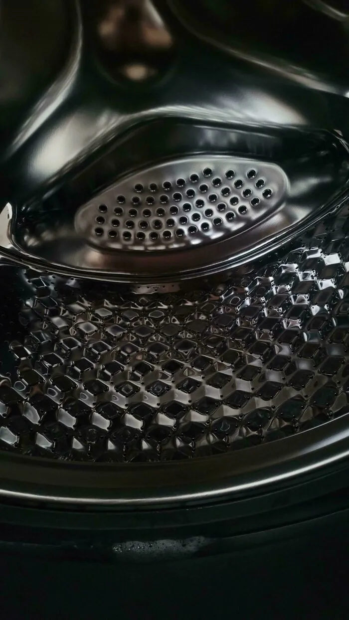 Close-up of a shiny metal surface with perforations demonstrating perfect camouflage in everyday objects.