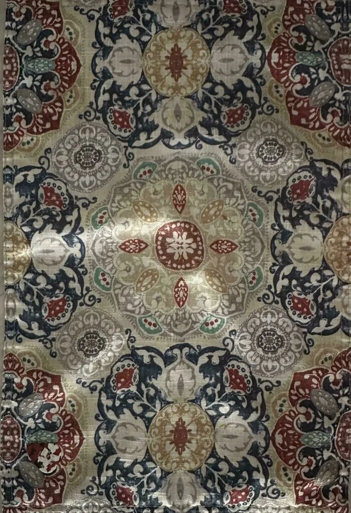 Intricate patterned fabric with perfectly camouflaged insect blending into the detailed floral design background