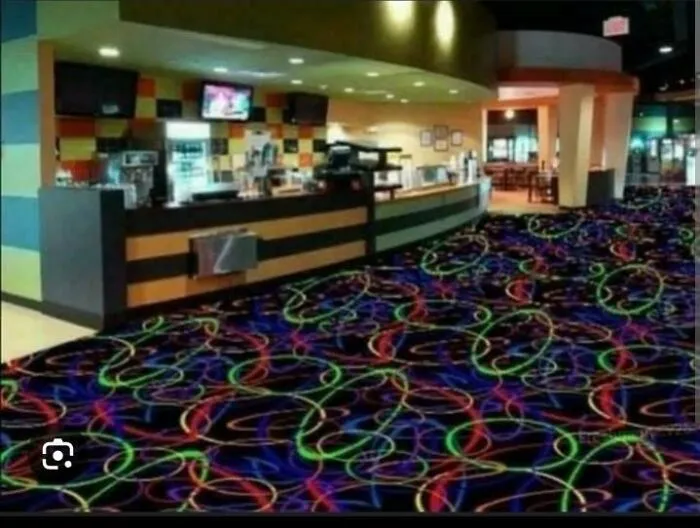’90s nostalgic bowling alley interior with neon swirl carpet and vintage snack bar counter under bright lights