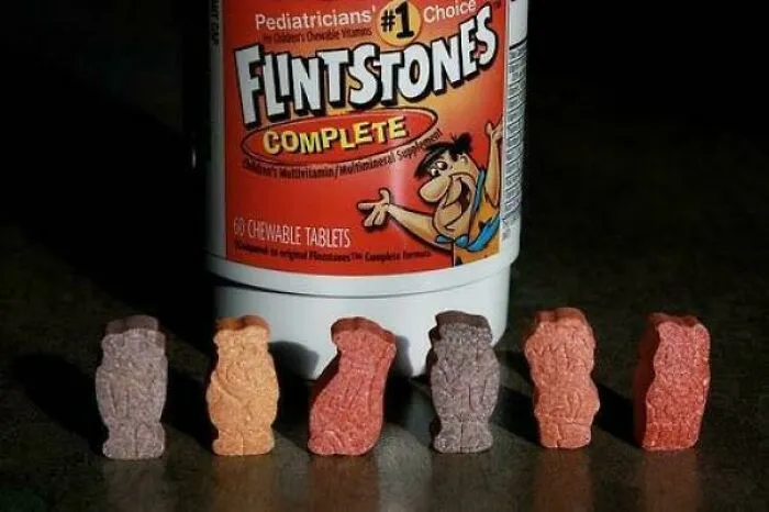 Flintstones Complete chewable vitamins shaped like characters, a nostalgic '90s kids favorite supplement bottle and tablets.