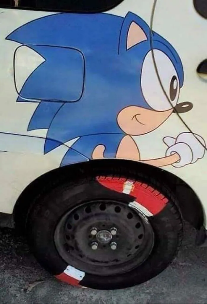 Sonic artwork on car with a creatively painted flat tire blending into the image in a weird and confusing way.