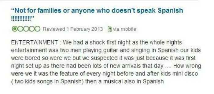 Customer review complaining about entertainment being in Spanish, expressing frustration with language and content choices.