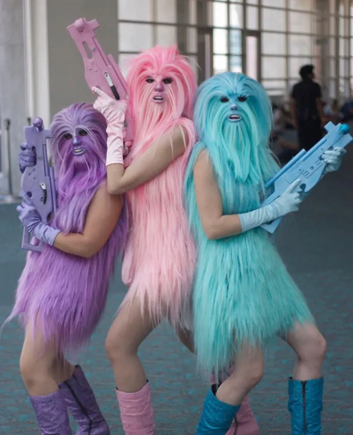 Unhinged costumes with colorful furry creatures holding toy weapons