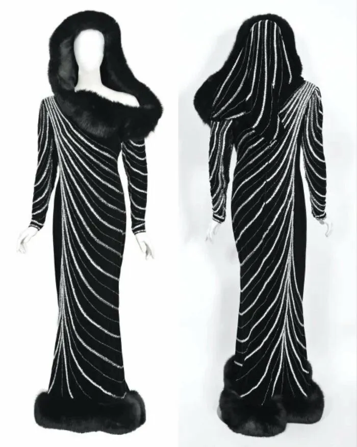 Black historical garment with fur trim and white swirling stripes, shown from front and back on mannequins.