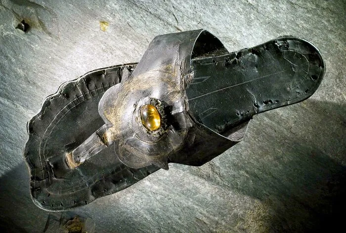 Ancient leather sandal with a gemstone decoration, an artefact that survived to give perspective on history and humanity.
