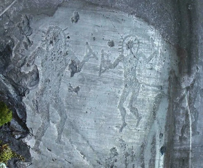 Ancient rock carvings of human figures and symbols, a fascinating artefact showing early human expression and culture.
