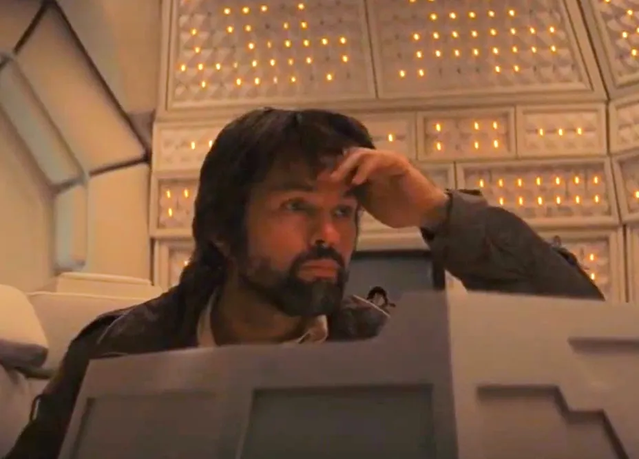 Dallas from Alien looking thoughtful inside spaceship control room with illuminated panels behind him