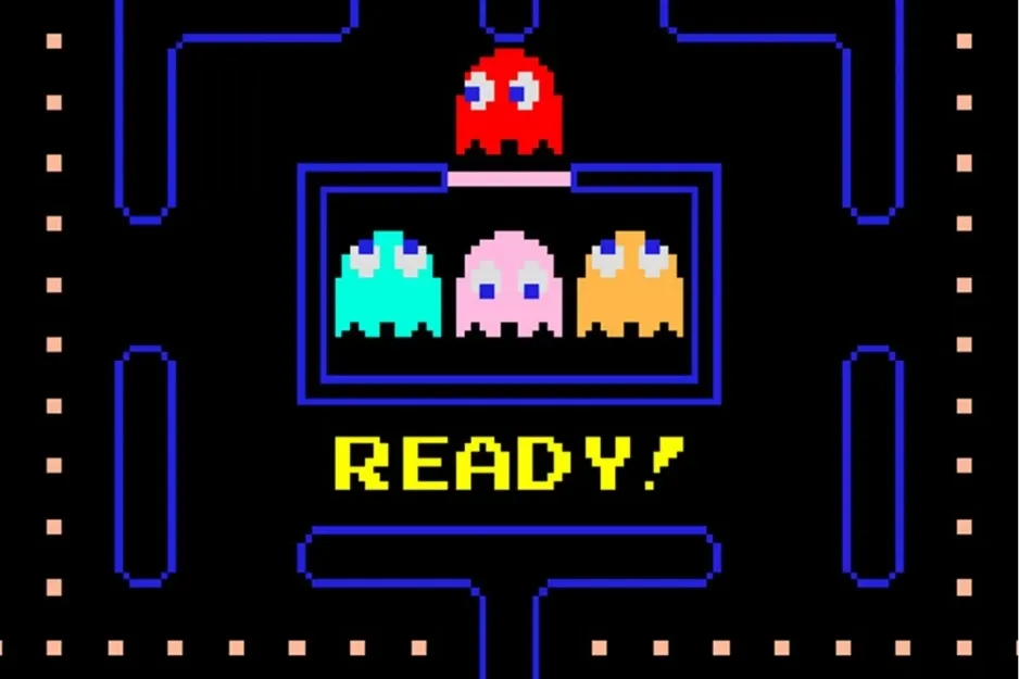 Pac-Man arcade game screen showing colorful ghosts and the word READY in classic pixel art style.