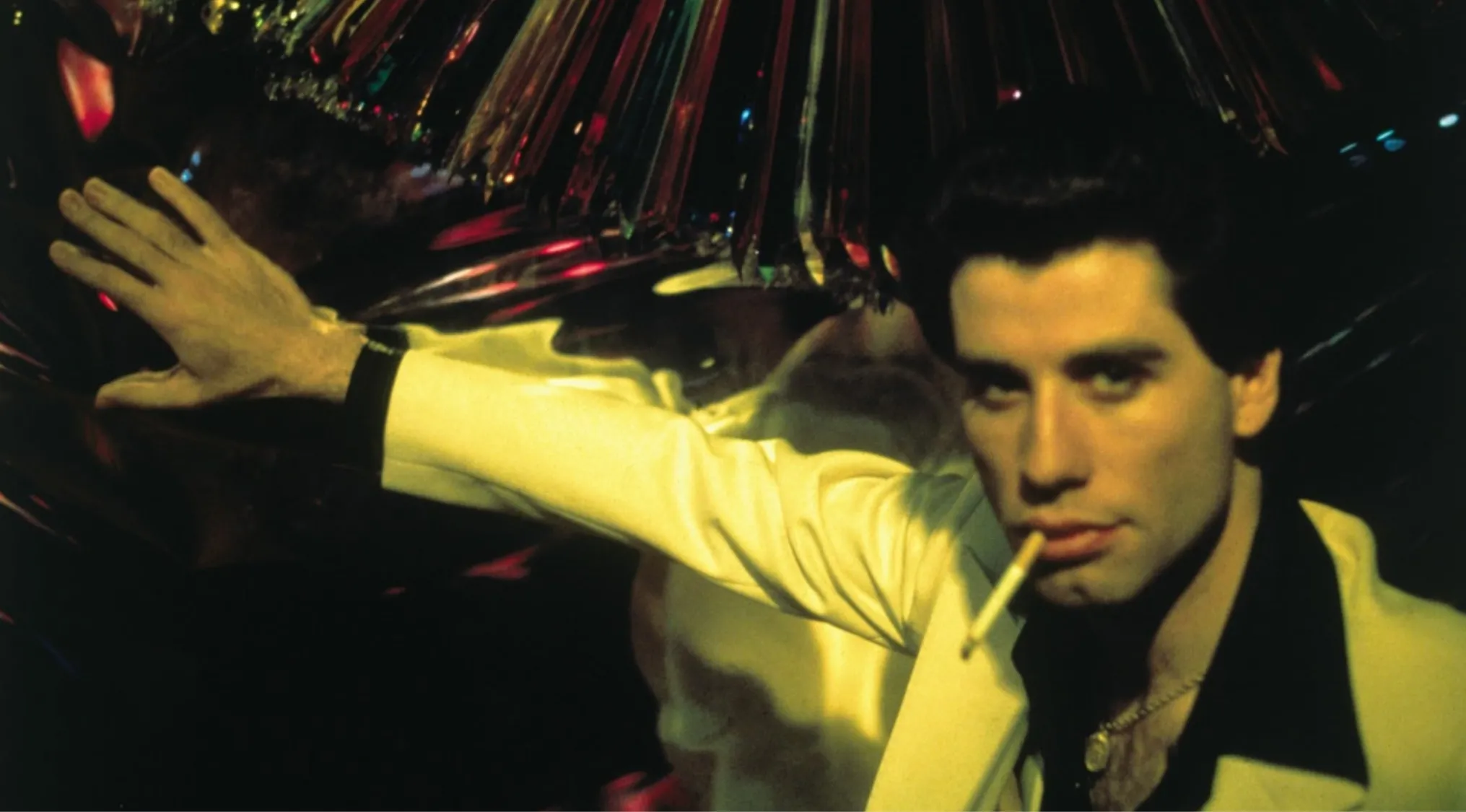 John Travolta as Tony Manero in the disco-themed movie Saturday Night Fever from 70s pop culture.