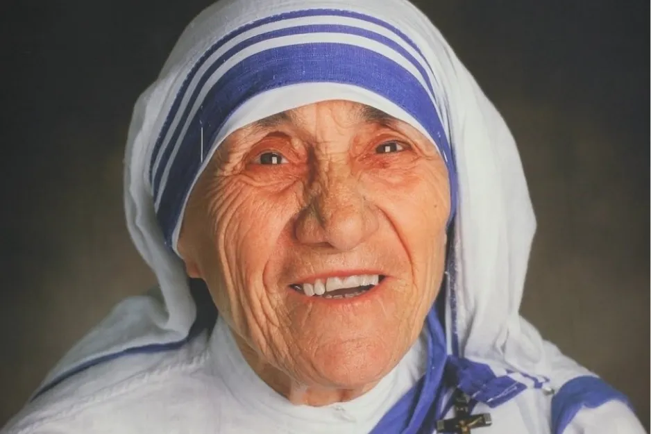 Mother Teresa wearing white and blue sari smiling, known for 1979 Nobel Peace Prize humanitarian work helping the poor.